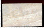 Aus Dream Marble slab showing soft ivory and beige bands with flowing white veining
