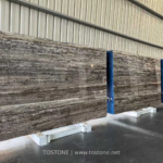 Black Travertine slabs with charcoal and grey-beige horizontal bands