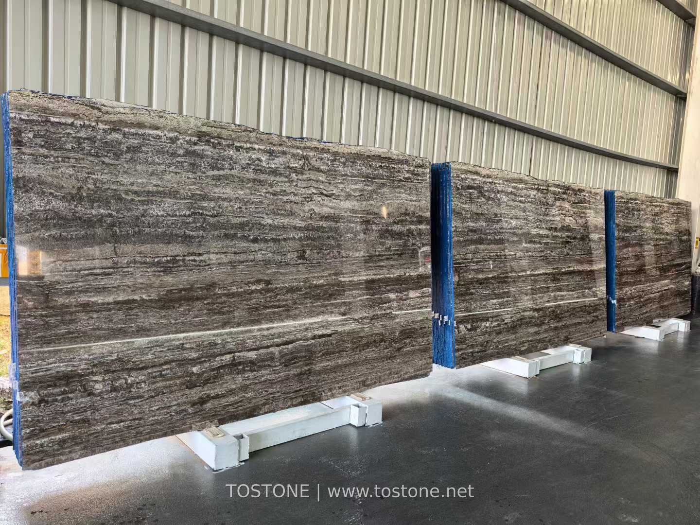 black-travertine-slab-01-tostone Black Travertine slabs with charcoal and grey-beige horizontal bands