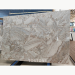 Full Blossom Marble slab with broad white and grey fragments and a blush-beige network of veining