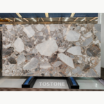 High-contrast Blossom Marble slab with white, grey and charcoal shapes in a warm beige-pink matrix