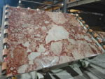 Blush Petals marble slab on workshop rollers with large pale areas and pink veining