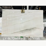 Brazilian Calacatta White Quartzite slab with diagonal grey veining and a darker branching band near the lower edge.