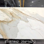 Calacatta Borghini marble full slab with sweeping grey and gold diagonal veins on a creamy white background