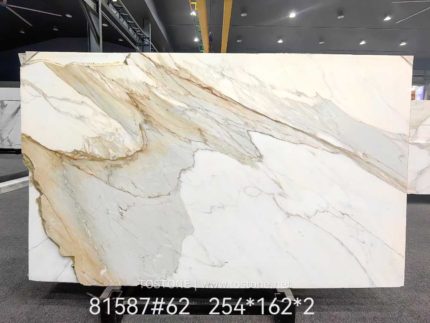 Calacatta Borghini marble full slab with sweeping grey and gold diagonal veins on a creamy white background