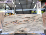 Calacatta Rosa marble slab with pale cream background and peach accents