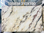 Calacatta Viola marble slab with diagonal plum-grey veining and warm gold accents across an ivory background