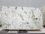 Italian Calacatta Viola marble slab with a pale ivory background and fine branching grey and warm gold veins