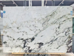 Italian Calacatta Viola marble slab with sweeping diagonal charcoal-grey veins over a creamy white background