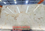Italian Ceppo marble slab with a light ivory background, pale grey fragments and scattered warm rose accents