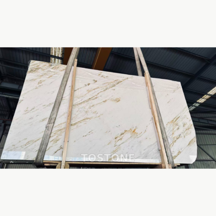 China Calacatta Gold stone slab with sweeping gold and gray diagonal veining in a warehouse