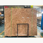 Front view of a Crystal Light Brown Marble slab with dense fine cream veining and green securing straps