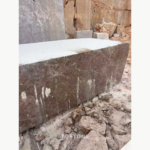 Crystal Light Brown Marble block showing a brown veined side face in a stone yard