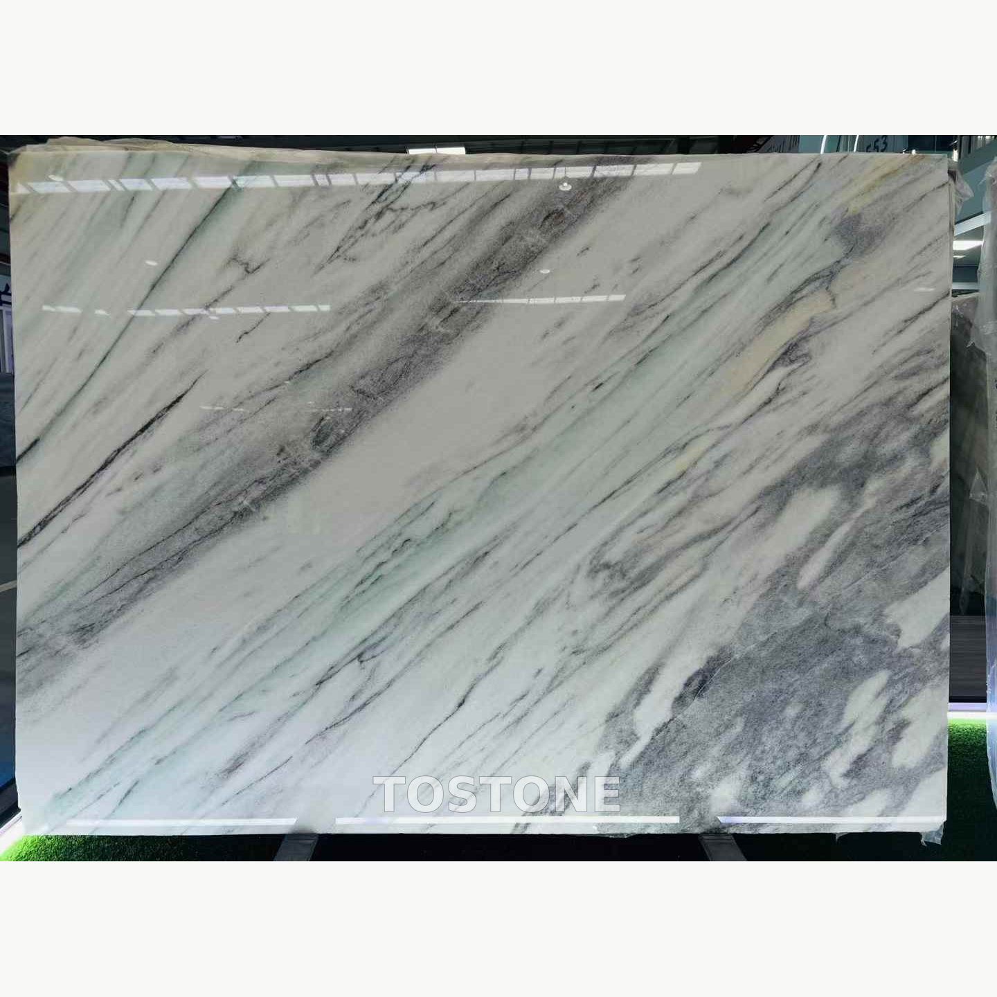desert-oasis-marble-slabs-01-tostone-watermark-partial-clean-square Desert Oasis Marble slab with diagonal charcoal-grey bands across an ivory and pale mint background