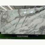 Angled Desert Oasis Marble slab showing broad pale mint areas and bold flowing grey-black veins