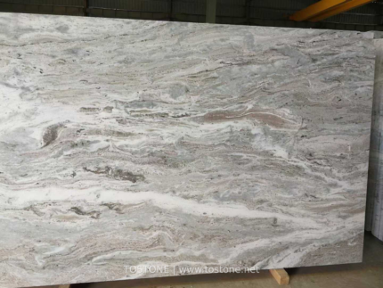 Front view of Fantasy Brown marble slab with flowing cream, grey and brown bands