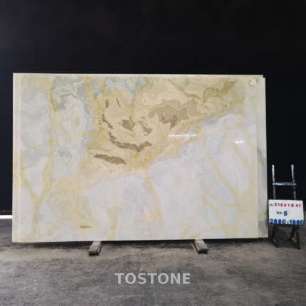 Golden Blue Jade Marble slab with a layered beige and taupe pattern above a broad ivory-white area.
