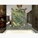 Interior design visualization of a Golden Silk Green Marble feature wall framed by dark wood and metallic trim.