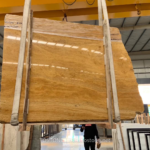 Golden Travertine Slab held upright with honey-gold horizontal banding