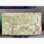 Gu Qing Yu stone slab with flowing green and cream bands, white outlines and burgundy veins