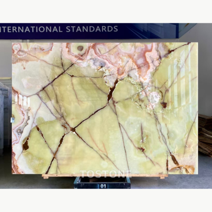 Gu Qing Yu stone slab with pale yellow-green fields, dark branching veins and blush-white bands