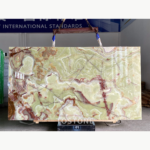 Gu Qing Yu stone slab held by lifting straps with pale green swirls and pink-brown veining