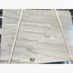 Guangxi White Marble slab with layered gray veining across a white background, marked B2