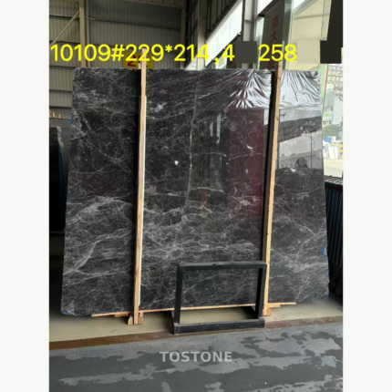 Hermes Grey Marble slab with a charcoal-grey base and dense silver-white veining on a timber support.