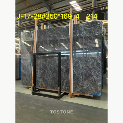 Angled view of Hermes Grey Marble slabs with sweeping silver-white veins and protective wrapping.