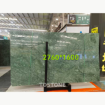 Indian Large Flower Green Marble slab on a showroom stand with pale green flecks and original size annotation