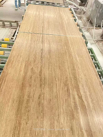 Iran Beige Travertine slabs arranged along a production line