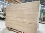 Angled Iran Super White Travertine slab showing warm linear layers