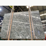 Iranian Green Marble slabs viewed from below, showing sage-grey fields and intricate dark and white veining
