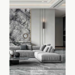 Living-room design reference with an Italian Silver Fir Marble patterned feature wall behind a gray sofa