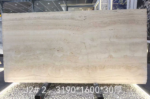 Italian Super White Travertine Vein Cut Slab displayed upright with pale cream horizontal layers