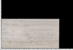 Italian Super White Travertine Vein Cut Slab against a dark background showing soft linear markings