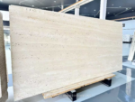 Angled view of Ivory Travertine slab with gentle horizontal layering