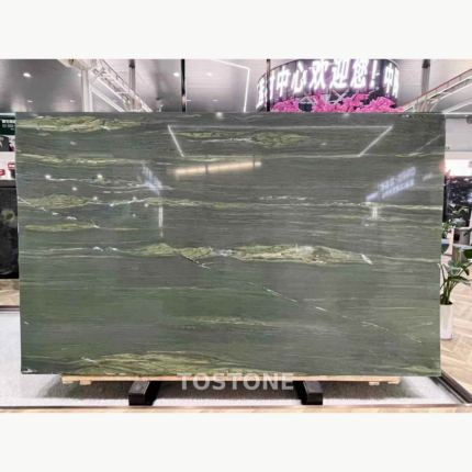 McLaren Green Marble slab in a showroom with deep olive-green colour and flowing pale green and white veins