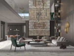 Interior design reference showing a tall patterned stone feature wall behind a living-room seating area