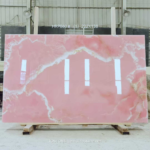 Pink Onyx Marble Slab with broad soft pink areas and flowing cream bands