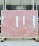 Pink Onyx Marble Slab with a delicate cream band across a pink background