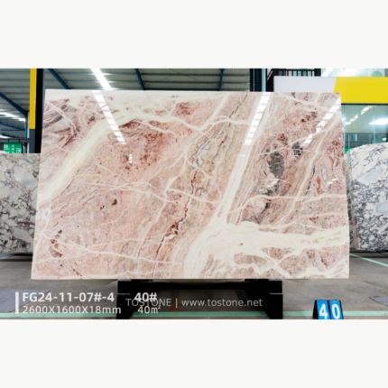 Rosa Picasso marble slab with rose accents and diagonal white veining