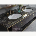 Double vanity design with a dark Platinum Diamond stone top, white basins and gold-toned fittings