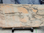 Portuguese pink marble slab with peach and ivory fields and branching grey natural patterns