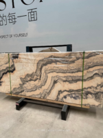 Portuguese pink marble slabs with warm beige and peach tones and bold wavy grey bands