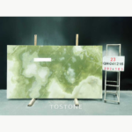 Qing Yu Marble slab with an olive-green upper field, white patches and crossing pale veins