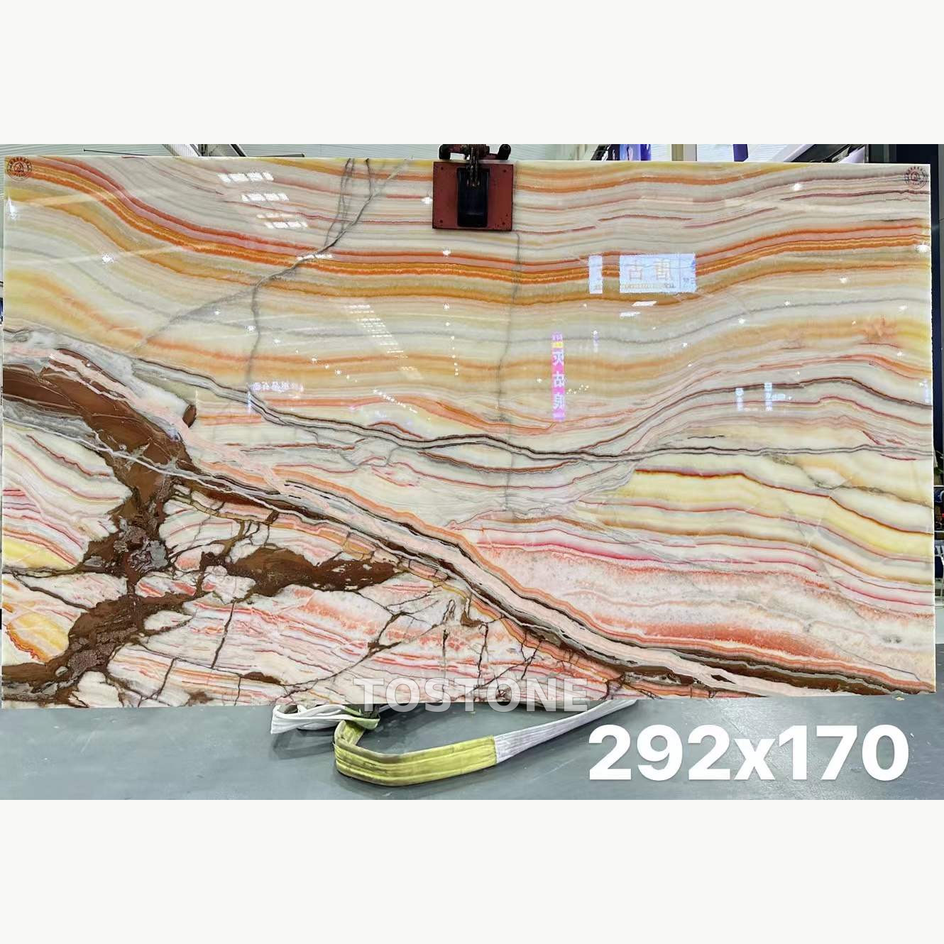 rainbow-agate-marble-01-square-review Rainbow Agate Marble slab with cream, amber and pink horizontal bands and bold brown branching patterns at the lower left.