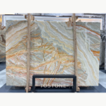 Rainbow Agate Marble slab with sweeping grey, white and amber layers and intricate orange-brown linear patterns.