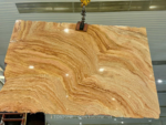 Rainbow Travertine Slab suspended by a clamp with curved honey-gold banding