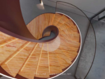 Design reference showing warm banded stone on a spiral staircase viewed from above